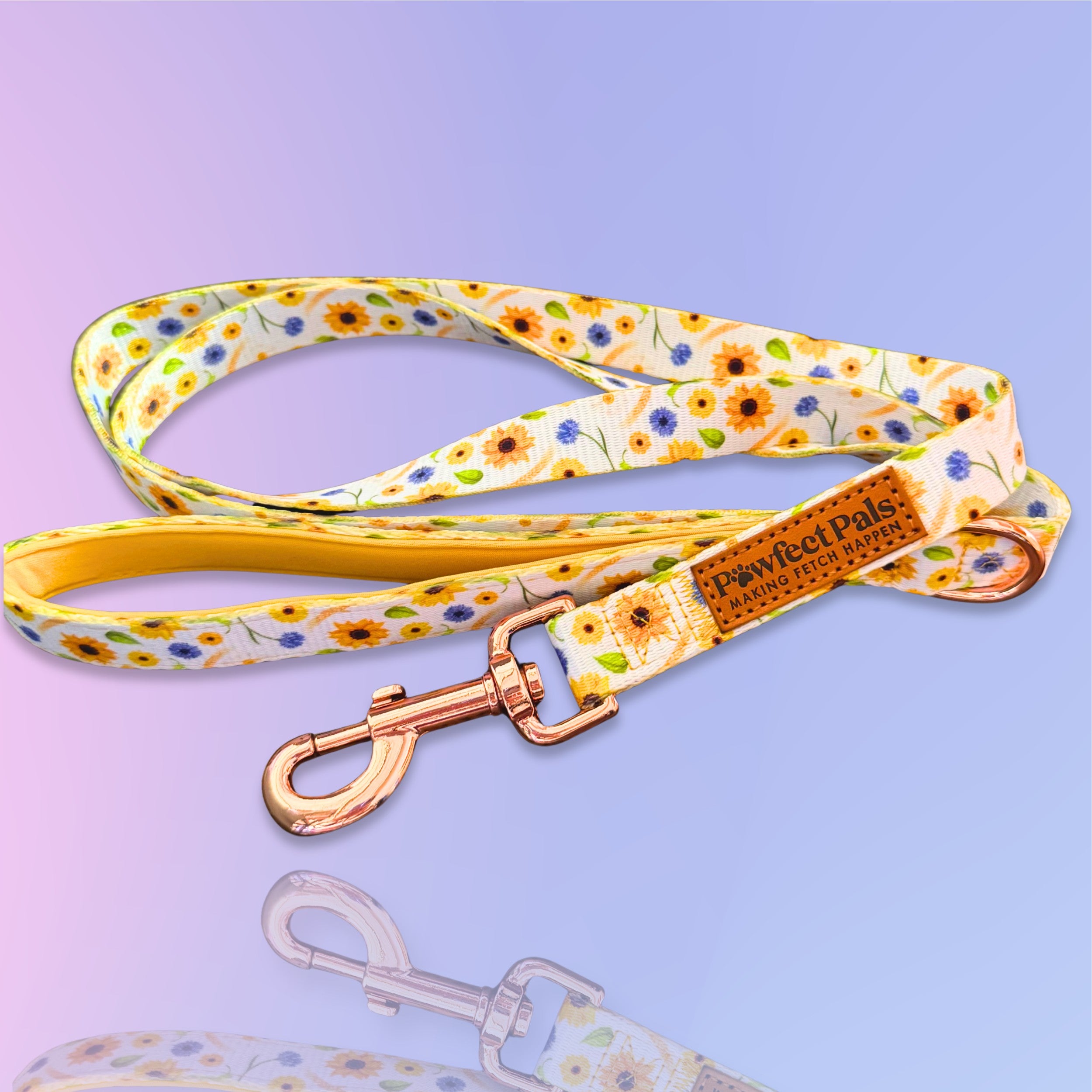 Floral-patterned dog leash with a gold clasp on a purple background