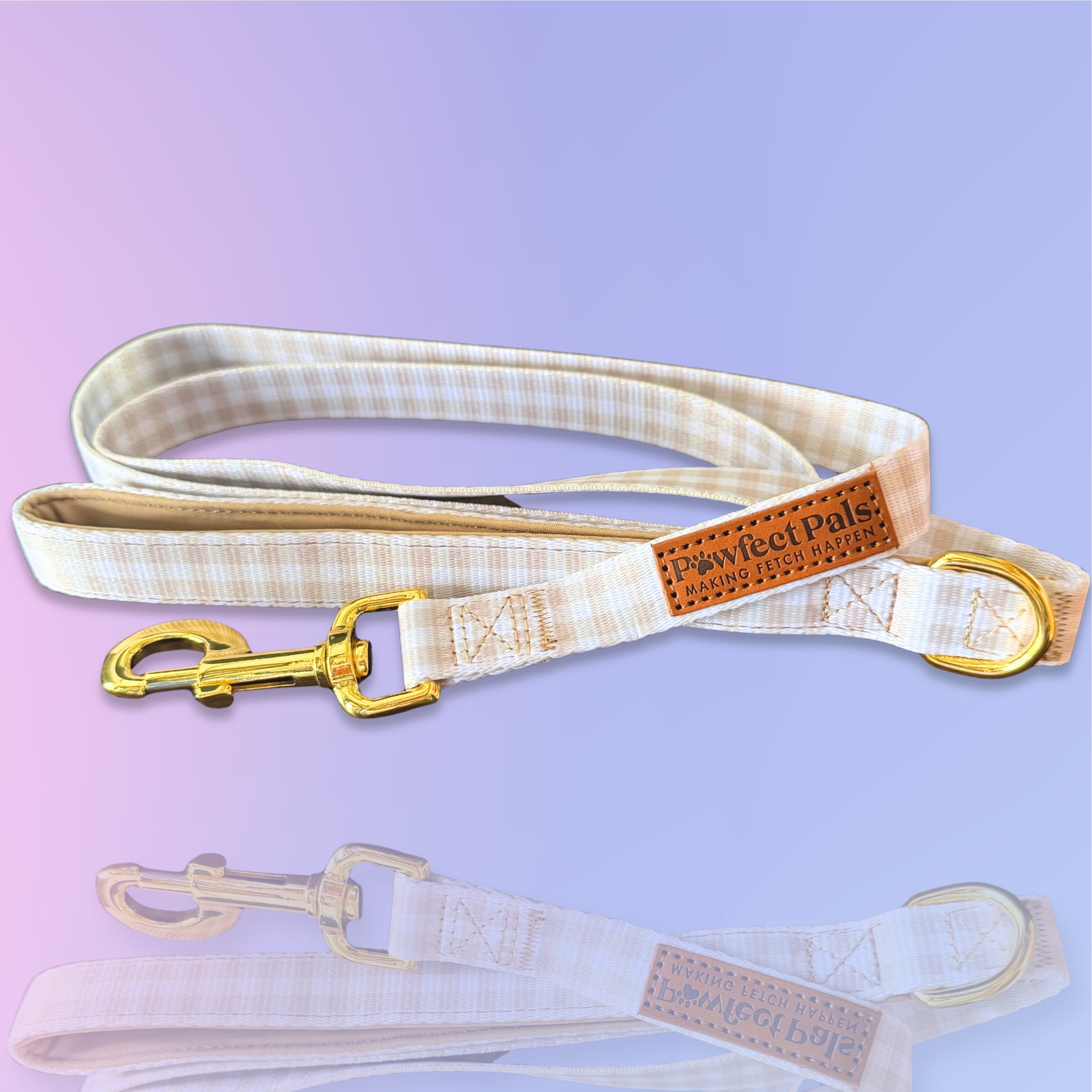 Dog leash with checkered pattern and gold hardware on a gradient purple background