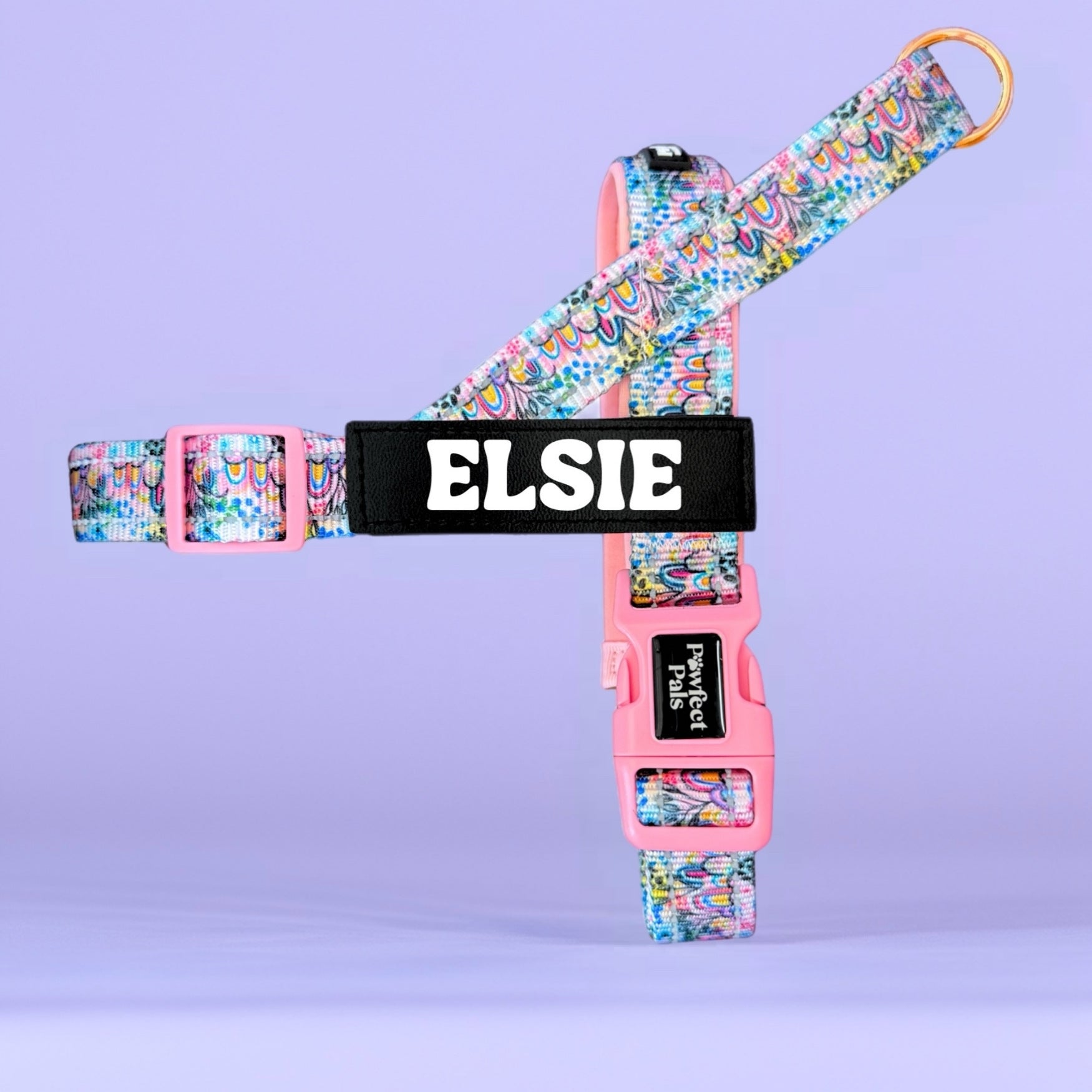 Colorful dog harness with 'Elsie' branding on a purple background