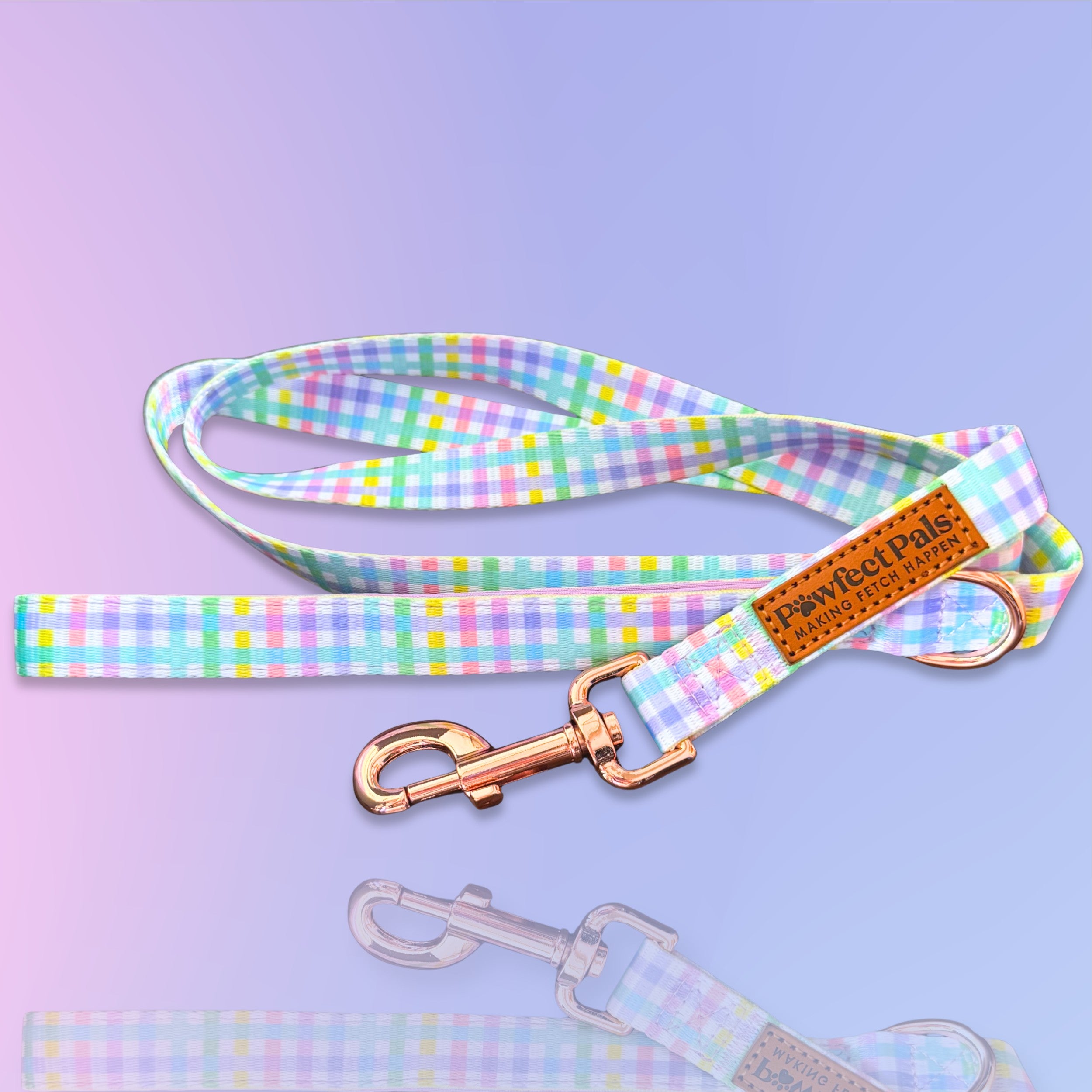 Pastel checkered dog leash with rose gold clasp on a purple background