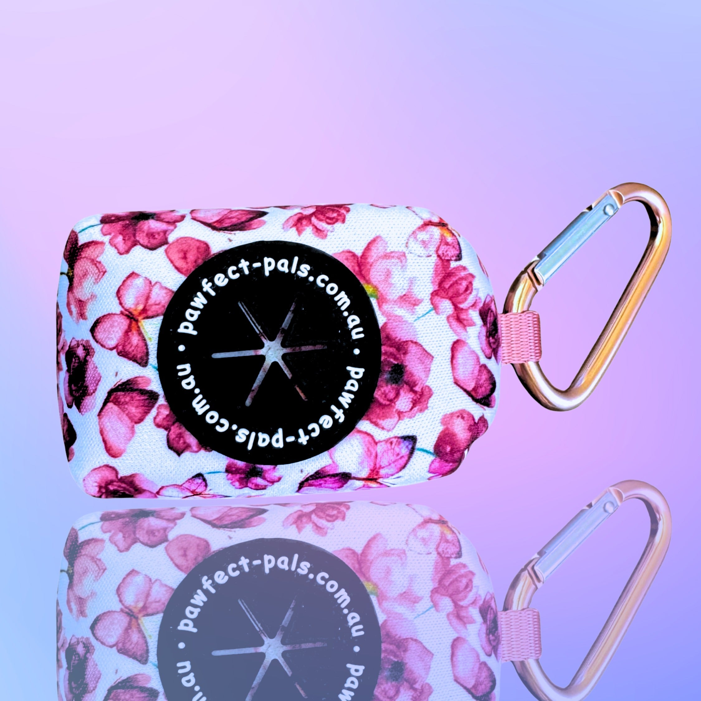Floral-patterned pouch with carabiners on a purple background